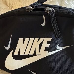 Nike Unisex Heritage hip pack with a repeating swoosh print.